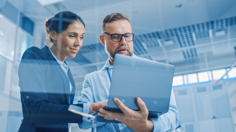 man and woman looking at laptop together