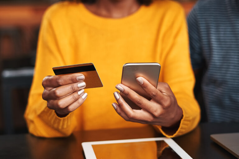 woman holding phone and card