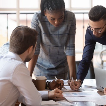 colleagues in discussion over a drawing