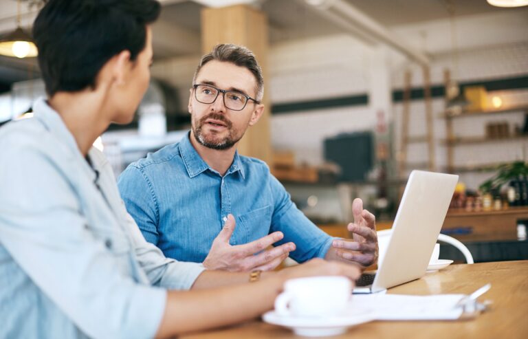 man at desk in discussion