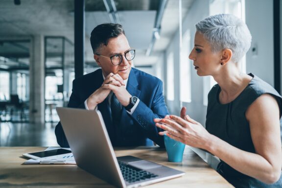 Business coworkers sitting at desk in discussion