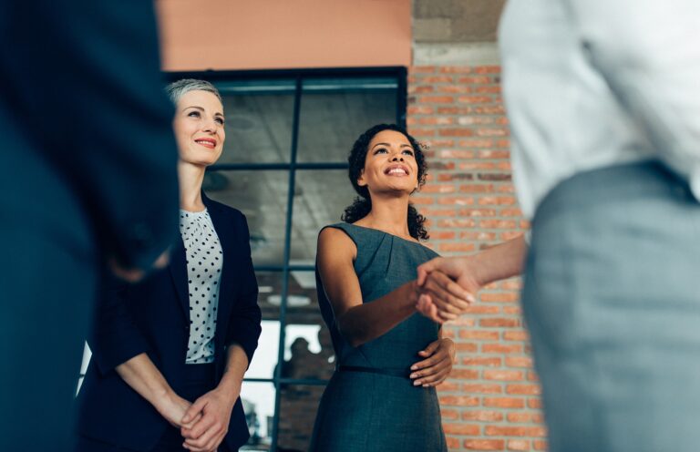 man and woman in office shaking hands