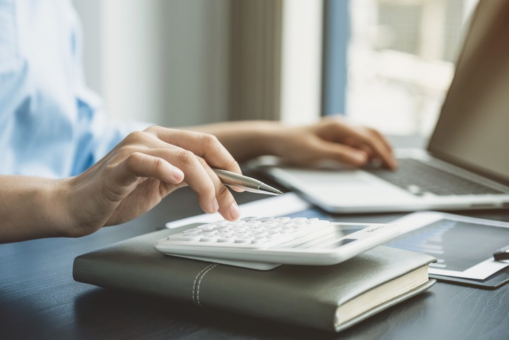 calculator and laptop on a desk