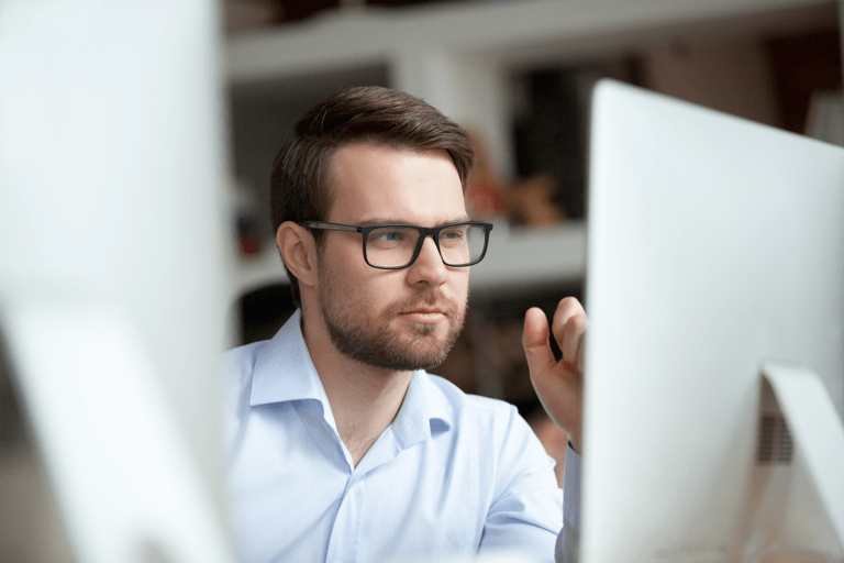 man musing at desktop screen