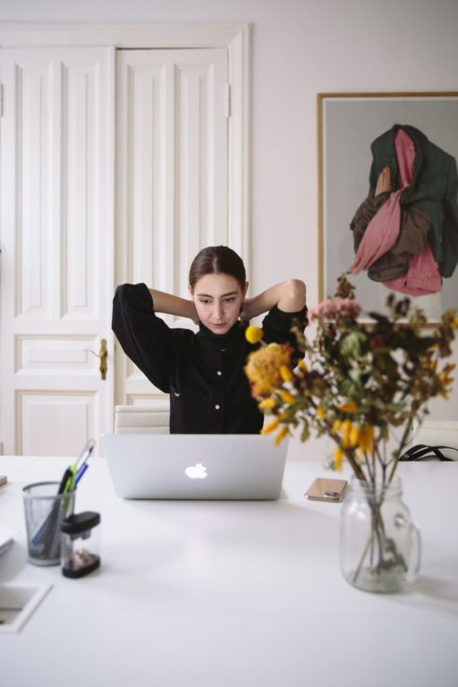 woman at laptop contemplating