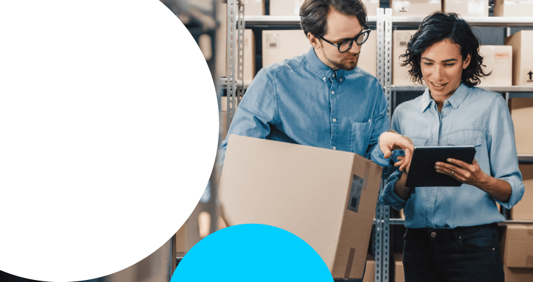 woman and man looking at tablet together in factory