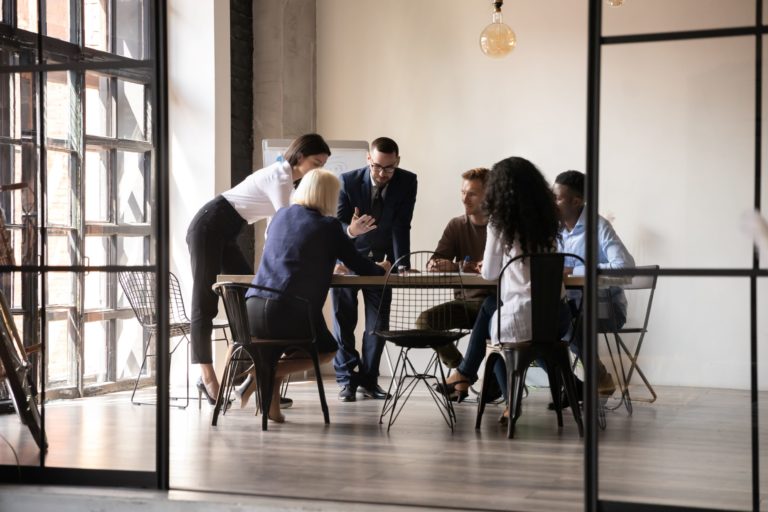 business people sitting around table talking