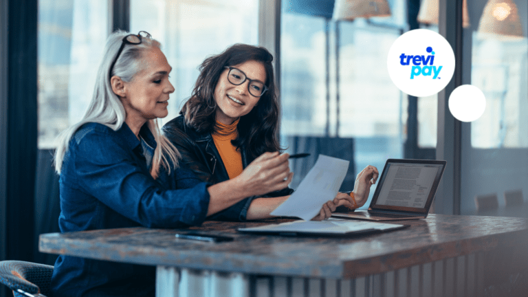 two women discussing a piece of paper