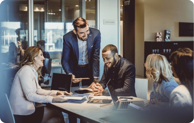 Business professionals sitting at a table working with each other