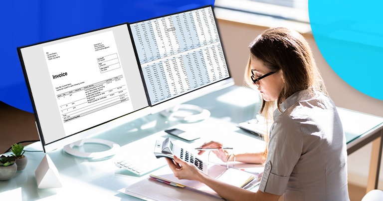 Woman working on an invoice by doing calculations on a calculator.