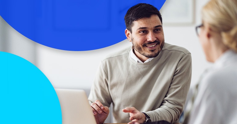 man smiling at desk