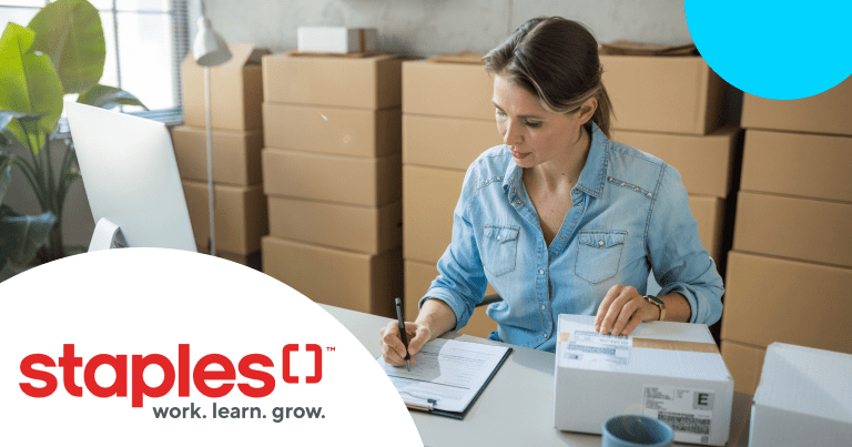 Woman packaging boxes for a business with Staples Logo