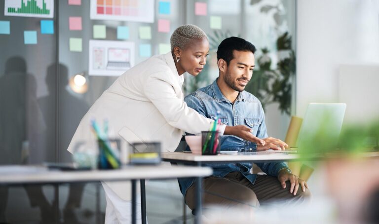 2 people looking at a laptop