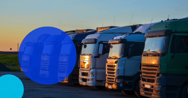 Australian commercial trucks lined up at sunset with a TreviPay droplet overlayed with white text saying 