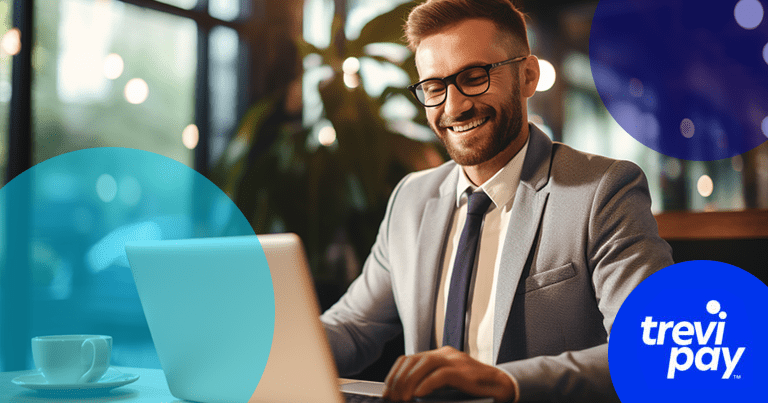 man in suit at laptop smiling with TreviPay logo