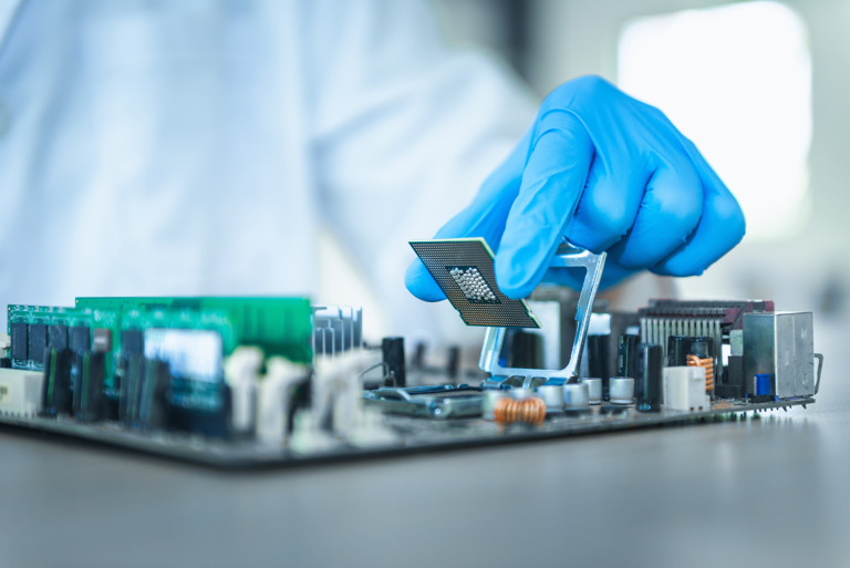 a person holding parts of an electrical board