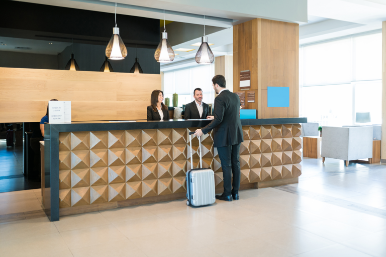 man talking to hotel workers