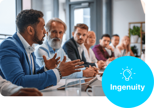 people sitting around a table looking at someone talking with the ingenuity symbol in the corner