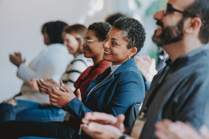 woman clapping at conference