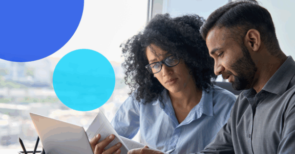 Two business people looking at the hidden costs of managing trade credit in-house.